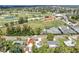 Aerial view features lush landscaping of the golf course, tennis courts, homes and mature trees throughout community at 1005 45Th W St, Bradenton, FL 34209