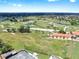 A sprawling golf course with lush landscaping and fairways and ponds, along with tennis courts for recreation at 1005 45Th W St, Bradenton, FL 34209