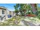 Lush backyard with mature trees, partial fencing, and ample space for outdoor activities at 1005 45Th W St, Bradenton, FL 34209