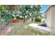 A spacious backyard featuring a large shed, a concrete pad, and a well-maintained lawn at 1005 45Th W St, Bradenton, FL 34209