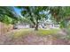 Well-maintained backyard featuring a storage shed, partial fencing, and mature trees at 1005 45Th W St, Bradenton, FL 34209