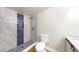 Bathroom features large shower with faux marble surround, blue accent tile, and wood look floors at 1005 45Th W St, Bradenton, FL 34209