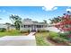 Inviting single-story home with a cozy front porch, beautifully landscaped yard, and a newly paved driveway at 1005 45Th W St, Bradenton, FL 34209