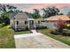 Attractive single-story home showcasing a spacious driveway, manicured lawn, and a charming covered front porch at 1005 45Th W St, Bradenton, FL 34209