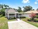 Charming front exterior with covered porch, landscaped yard and plenty of space to park at 1005 45Th W St, Bradenton, FL 34209