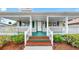 Inviting front porch with vibrant steps and lush landscaping, creating a welcoming entrance to this home at 1005 45Th W St, Bradenton, FL 34209