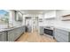 Bright kitchen with stainless steel appliances, light grey cabinets, white backsplash, and granite countertops at 1005 45Th W St, Bradenton, FL 34209