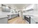 Modern kitchen with stainless steel appliances, light grey cabinets, white backsplash, and granite countertops at 1005 45Th W St, Bradenton, FL 34209