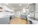 Open kitchen with stainless steel appliances, light grey cabinets, white backsplash, and granite countertops at 1005 45Th W St, Bradenton, FL 34209