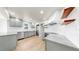 Modern kitchen with stainless steel appliances, light grey cabinets, white backsplash, and granite countertops at 1005 45Th W St, Bradenton, FL 34209