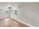 Neutral living room featuring wood flooring, recessed lighting, and dual windows at 1005 45Th W St, Bradenton, FL 34209