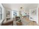 Bright, open-concept living room with hardwood floors, large windows, and contemporary decor with an adjacent dining room at 1005 45Th W St, Bradenton, FL 34209