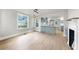 Bright living area with hardwood floors, modern lighting, and an open layout to the kitchen and dining spaces at 1005 45Th W St, Bradenton, FL 34209