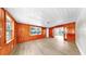 Cozy living room with wood paneled walls, wood ceiling, and lots of natural light from the windows at 1005 45Th W St, Bradenton, FL 34209