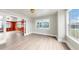 Spacious living area with hardwood floors, large windows, and elegant woodwork in the adjacent bonus room at 1005 45Th W St, Bradenton, FL 34209