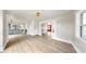 Large living area with hardwood floors and an open floor plan leading to the modern kitchen and bonus room at 1005 45Th W St, Bradenton, FL 34209