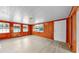 Bright living room with wood paneled walls, wood ceiling, and lots of natural light from the windows at 1005 45Th W St, Bradenton, FL 34209