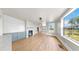 Light-filled living area features hardwood floors, modern lighting, and seamless flow into the kitchen and bonus room at 1005 45Th W St, Bradenton, FL 34209