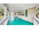 Exterior front porch features teal floor, white railings and exterior paint at 1005 45Th W St, Bradenton, FL 34209