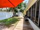 Charming backyard with a wooden walkway, storage shed, grill, mature trees, and partial fence at 1006 Tropical Dr, Bradenton, FL 34208