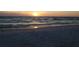 Beautiful beach at sunset with serene ocean views and golden light reflecting on the water at 1006 Tropical Dr, Bradenton, FL 34208