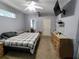 Comfortable bedroom with plaid comforter, gray walls, and a ceiling fan at 1006 Tropical Dr, Bradenton, FL 34208