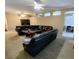Spacious living room with tan paint, black leather sofas and ceiling fans at 1006 Tropical Dr, Bradenton, FL 34208