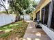 Charming backyard featuring a detached shed, partial fencing, mature trees, and a cozy wooden deck at 1006 Tropical E Dr, Bradenton, FL 34208
