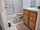 Bathroom featuring a toilet, sink, wooden cabinets and a sliding shower door at 1006 Tropical E Dr, Bradenton, FL 34208