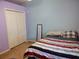 Comfortable bedroom featuring a full bed, large closet and hardwood floors at 1006 Tropical E Dr, Bradenton, FL 34208
