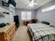 Comfortable bedroom with neutral colors, a ceiling fan and large window offering natural light at 1006 Tropical E Dr, Bradenton, FL 34208