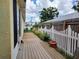 Deck with a well-maintained white picket fence and landscaping, offering a private outdoor space at 1006 Tropical E Dr, Bradenton, FL 34208