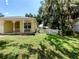 View of the landscaped front yard with white picket fence enhancing the curb appeal of the home at 1006 Tropical E Dr, Bradenton, FL 34208