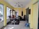 Bright workout room featuring ample space, a ceiling fan, and a full weight set with punching bags at 1006 Tropical E Dr, Bradenton, FL 34208