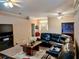 Open living room featuring dark leather seating, unique coffee table, and a large front window at 1006 Tropical E Dr, Bradenton, FL 34208