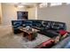 Spacious living room showcases a sectional leather sofa and a modern, rustic style coffee table at 1006 Tropical E Dr, Bradenton, FL 34208