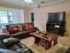 Comfortable living room features a large leather sofa and a unique wood coffee table at 1006 Tropical E Dr, Bradenton, FL 34208