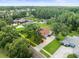 Aerial view of a well-landscaped home with mature trees and a driveway in a residential neighborhood at 1015 Hastings Ct, Lutz, FL 33548