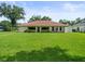 Well-maintained backyard showcasing lush green grass and the home's exterior, great for entertaining at 1015 Hastings Ct, Lutz, FL 33548