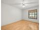 Bedroom with hardwood floors, neutral wall color, and a single window at 1015 Hastings Ct, Lutz, FL 33548