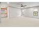 Spacious bedroom with carpet, ceiling fan, and a view of a bathroom area at 1015 Hastings Ct, Lutz, FL 33548