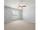Clean, neutral bedroom with carpet flooring, ceiling fan, and window with blinds at 1015 Hastings Ct, Lutz, FL 33548