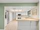 Well-lit kitchen showcasing white cabinetry, modern appliances, and a functional layout for easy meal preparation at 1015 Hastings Ct, Lutz, FL 33548