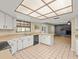 Bright kitchen with white cabinetry and a unique lighting fixture over the tile floor at 1015 Hastings Ct, Lutz, FL 33548