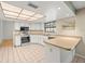 Bright kitchen featuring white cabinets, modern appliances, and ample counter space at 1015 Hastings Ct, Lutz, FL 33548