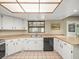 Updated kitchen boasting white cabinetry, modern appliances, and a functional layout at 1015 Hastings Ct, Lutz, FL 33548