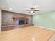 Spacious living room with hardwood floors, a brick fireplace, and neutral paint colors for a bright atmosphere at 1015 Hastings Ct, Lutz, FL 33548