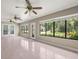 Spacious sunroom with tile flooring, multiple windows, and three ceiling fans at 1015 Hastings Ct, Lutz, FL 33548