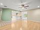 Open-concept living area connecting to the kitchen, featuring hardwood floors and abundant natural light at 1015 Hastings Ct, Lutz, FL 33548