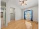 Living room features hardwood floors, ceiling fan, and a large window with blue curtains at 1015 Hastings Ct, Lutz, FL 33548